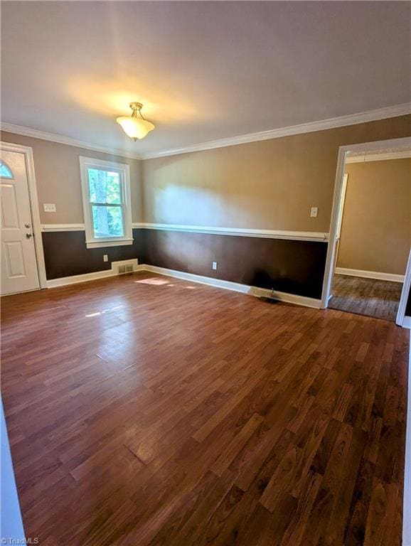 5675 Main St, Bethania, NC 27040 - empty room with dark wood-style floors and ornamental molding