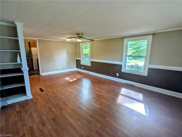 5675 Main St, Bethania, NC 27040 - spare room featuring healthy amount of natural light, ornamental molding, wood finished floors, a ceiling fan, and ornate columns