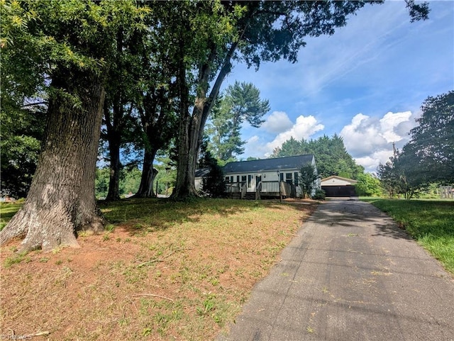 5675 Main St, Bethania, NC 27040 - ranch-style house featuring a wooden deck and a front yard