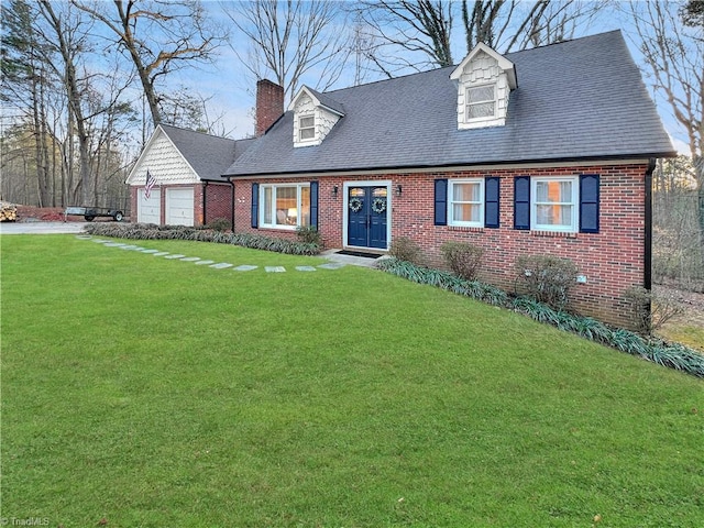 new england style home featuring a front yard and a garage