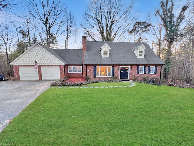 view of front of house with a front yard and a garage