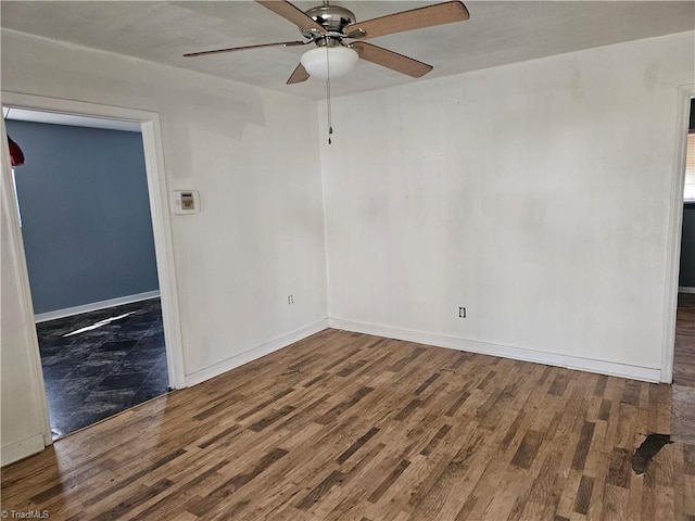 spare room with wood-type flooring and ceiling fan