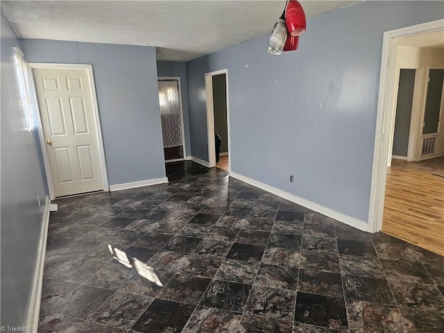 unfurnished bedroom featuring a textured ceiling