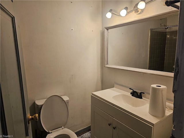 bathroom featuring vanity, toilet, and walk in shower