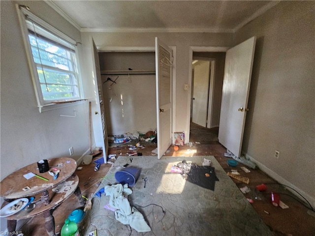 unfurnished bedroom featuring crown molding and a closet