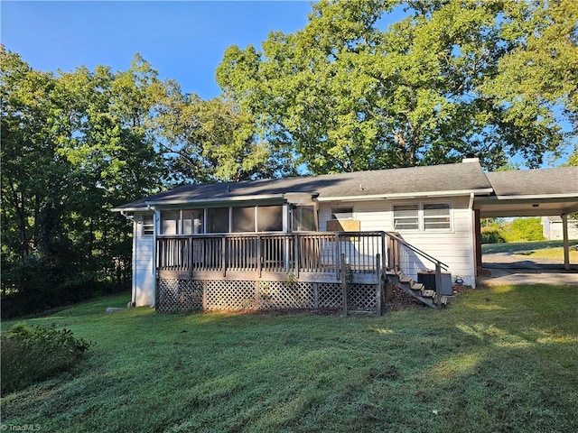 back of house with a wooden deck and a yard