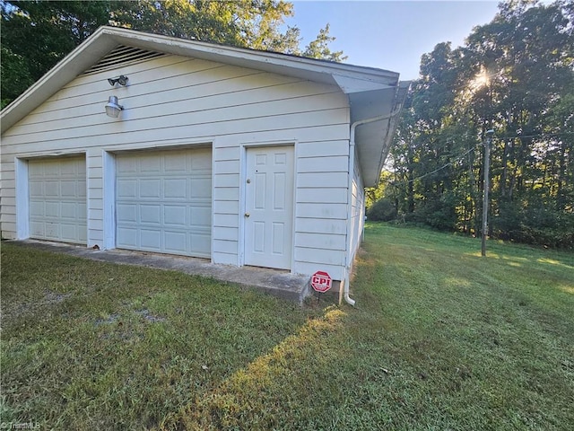 garage featuring wood walls and a yard