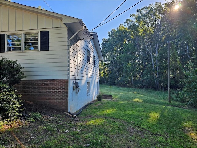 view of property exterior with a yard