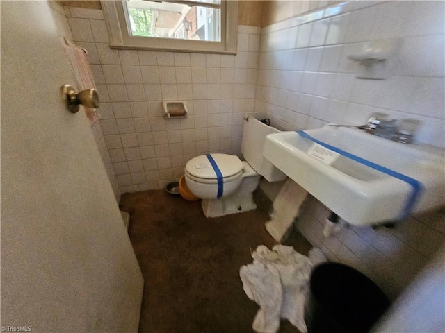 bathroom with tile walls and toilet