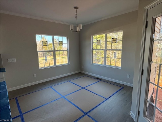 unfurnished dining area with crown molding and a chandelier