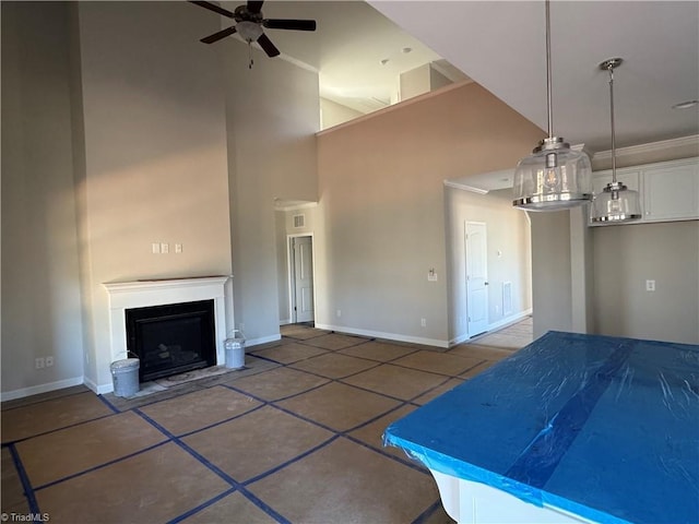 interior space featuring a towering ceiling and ceiling fan