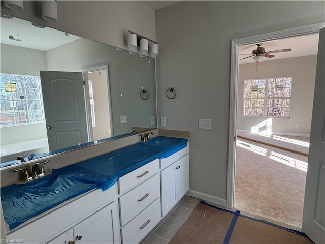 bathroom featuring tile patterned flooring, vanity, and ceiling fan