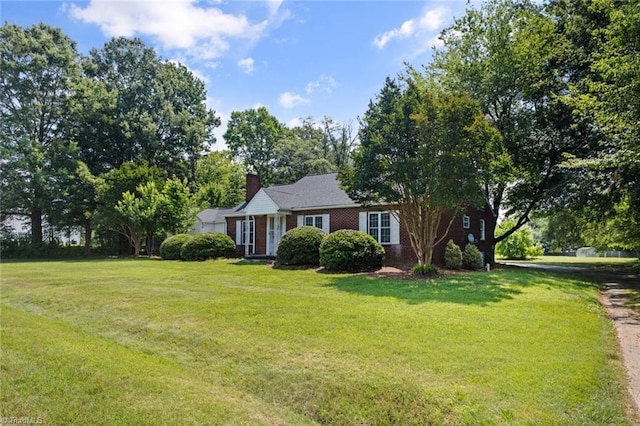 1425 Union Cross Rd, Kernersville, NC 27284 - view of front of house with a front lawn, a chimney, and brick siding
