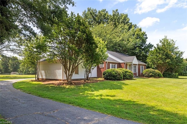 1425 Union Cross Rd, Kernersville, NC 27284 - view of front of home featuring asphalt driveway, a front lawn, brick siding, and a carport
