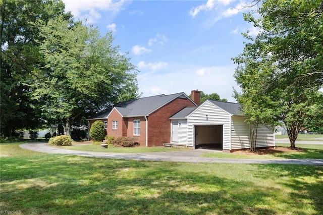 1425 Union Cross Rd, Kernersville, NC 27284 - view of front of house featuring a front yard, an outbuilding, an attached garage, driveway, and a chimney