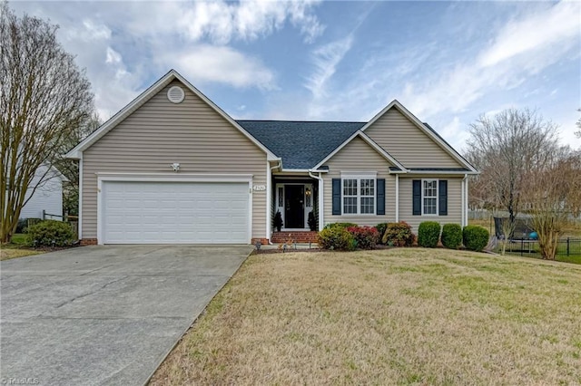 single story home featuring a trampoline, a shingled roof, concrete driveway, a front yard, and an attached garage