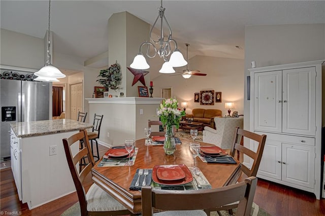 dining room featuring vaulted ceiling, ceiling fan with notable chandelier, and dark wood-style flooring