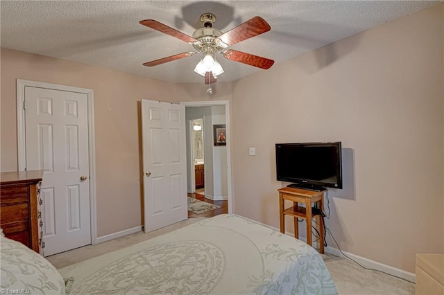 bedroom featuring baseboards, carpet floors, a textured ceiling, and ceiling fan