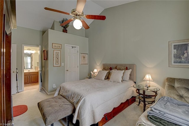 bedroom with baseboards, high vaulted ceiling, ceiling fan, ensuite bathroom, and light carpet