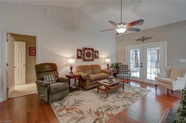 living room with visible vents, ceiling fan, french doors, hardwood / wood-style flooring, and high vaulted ceiling