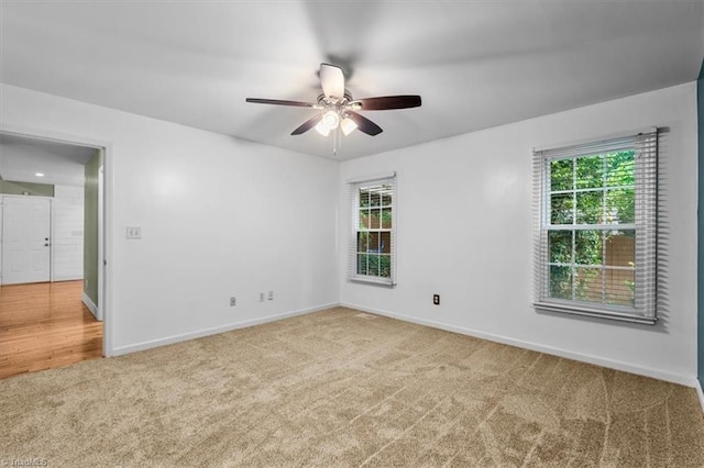 empty room with plenty of natural light, baseboards, a ceiling fan, and carpet floors
