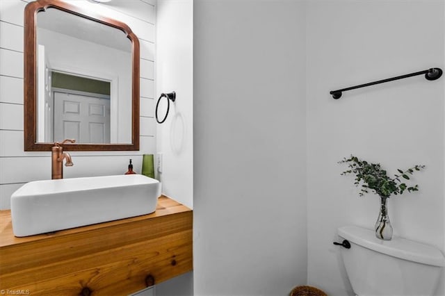 half bathroom with toilet and vanity