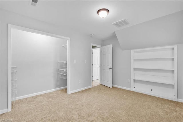 unfurnished bedroom featuring carpet floors, baseboards, visible vents, and a closet