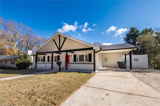 single story home featuring a front lawn, covered porch, and a carport