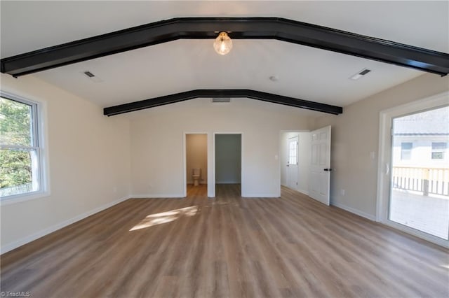 interior space with vaulted ceiling with beams and light wood-type flooring