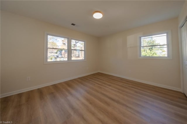 spare room with hardwood / wood-style floors