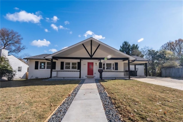 view of front of property with a carport, covered porch, and a front yard