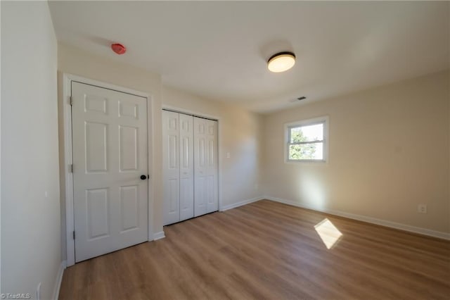 unfurnished bedroom featuring hardwood / wood-style flooring