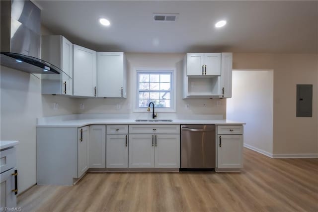 kitchen with dishwasher, wall chimney range hood, sink, light hardwood / wood-style flooring, and white cabinetry