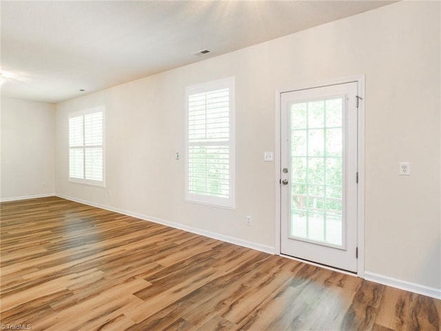 1307 Montreux Ct, Mebane, NC 27302 - interior space with a wealth of natural light, wood finished floors, and baseboards