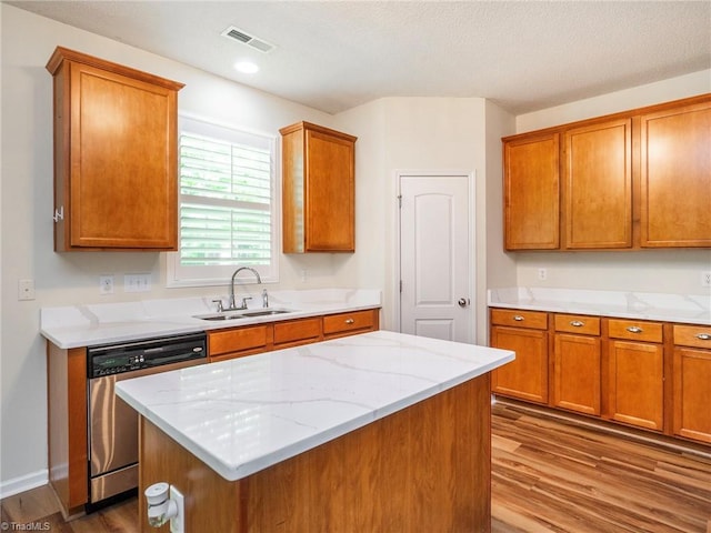 1307 Montreux Ct, Mebane, NC 27302 - kitchen featuring wood finished floors, a sink, brown cabinetry, visible vents, and dishwasher
