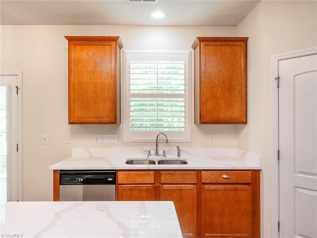 1307 Montreux Ct, Mebane, NC 27302 - kitchen featuring brown cabinetry, light countertops, a sink, and stainless steel dishwasher