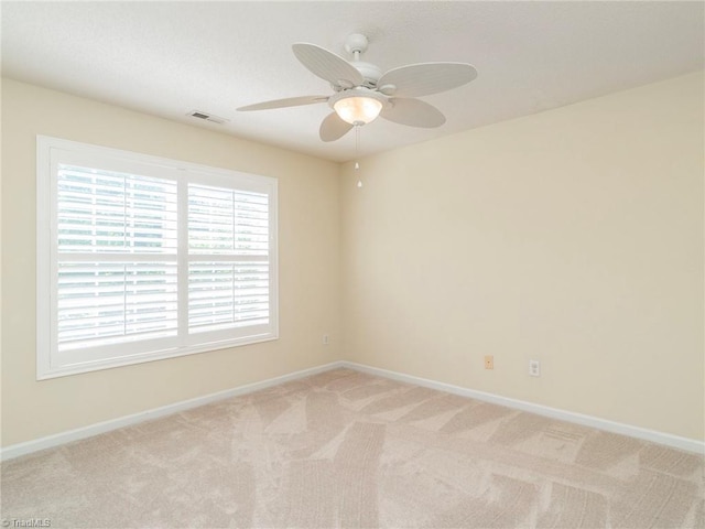 1307 Montreux Ct, Mebane, NC 27302 - empty room featuring light colored carpet, visible vents, baseboards, and a ceiling fan