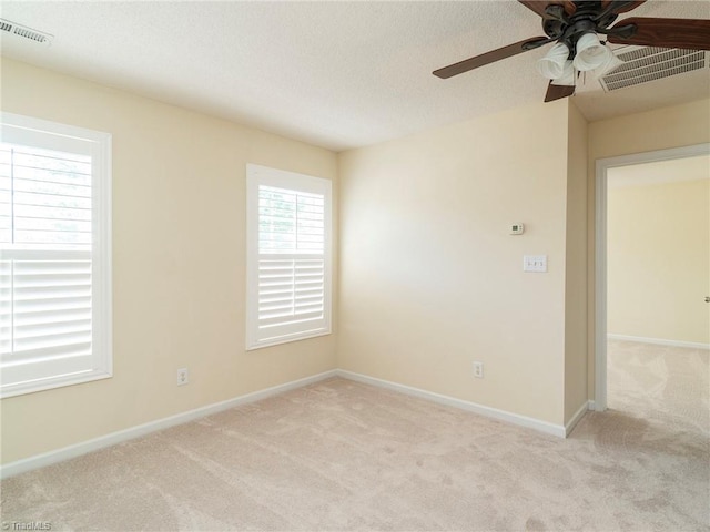 1307 Montreux Ct, Mebane, NC 27302 - unfurnished room with visible vents, baseboards, ceiling fan, and light carpet