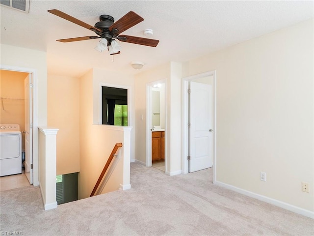1307 Montreux Ct, Mebane, NC 27302 - interior space featuring washer / clothes dryer, baseboards, ceiling fan, visible vents, and light carpet