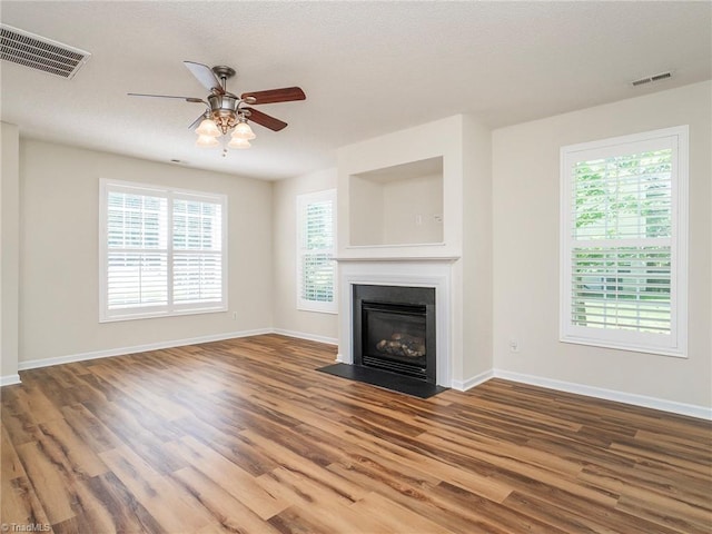 1307 Montreux Ct, Mebane, NC 27302 - unfurnished living room featuring baseboards, ceiling fan, visible vents, and wood finished floors