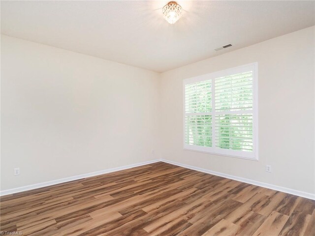 1307 Montreux Ct, Mebane, NC 27302 - spare room with visible vents, wood finished floors, and baseboards
