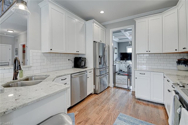 231 Plumstead Ln, Clemmons, NC 27012 - kitchen with appliances with stainless steel finishes, a sink, ornamental molding, light wood-style floors, and white cabinetry