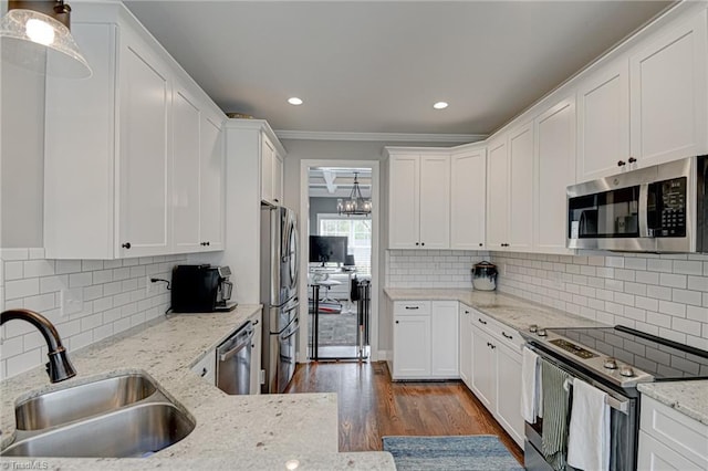 231 Plumstead Ln, Clemmons, NC 27012 - kitchen with appliances with stainless steel finishes, a sink, white cabinetry, ornamental molding, and recessed lighting