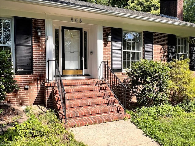 508 Audubon Dr, Greensboro, NC 27410 - view of exterior entry with brick siding and a chimney