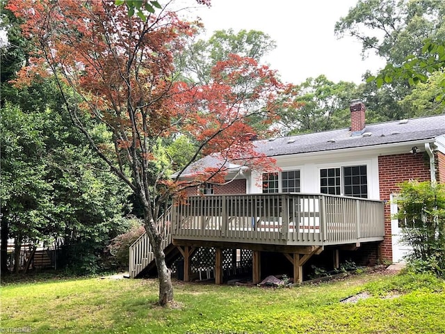 508 Audubon Dr, Greensboro, NC 27410 - back of house with a yard, a chimney, a deck, brick siding, and roof with shingles
