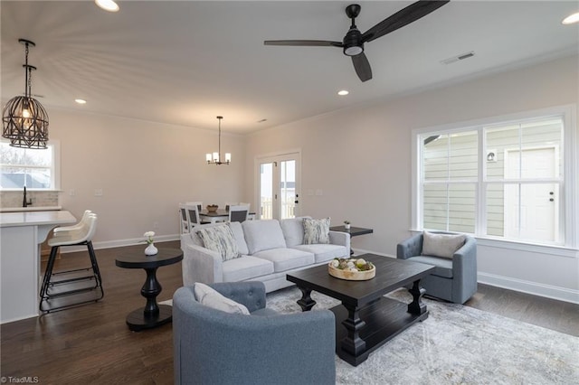 1815 Cleburne Ter, Kernersville, NC 27284 - living area with a chandelier, healthy amount of natural light, dark wood finished floors, ceiling fan, and recessed lighting