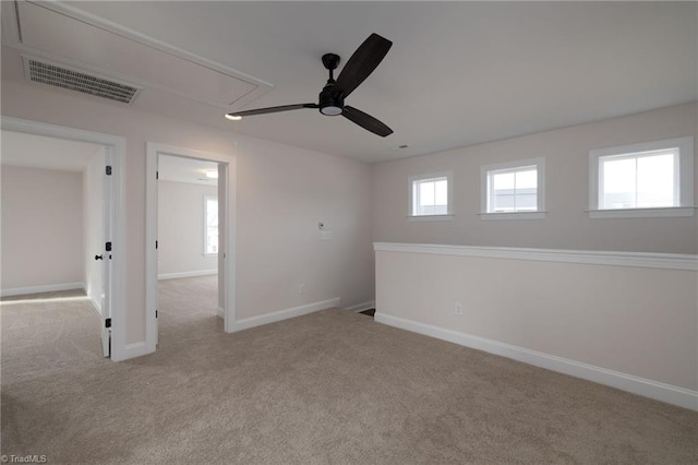1815 Cleburne Ter, Kernersville, NC 27284 - spare room featuring attic access, carpet, ceiling fan, and baseboards