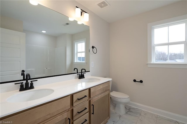 1815 Cleburne Ter, Kernersville, NC 27284 - bathroom with marble look tiles, toilet, double vanity, a shower, and baseboards