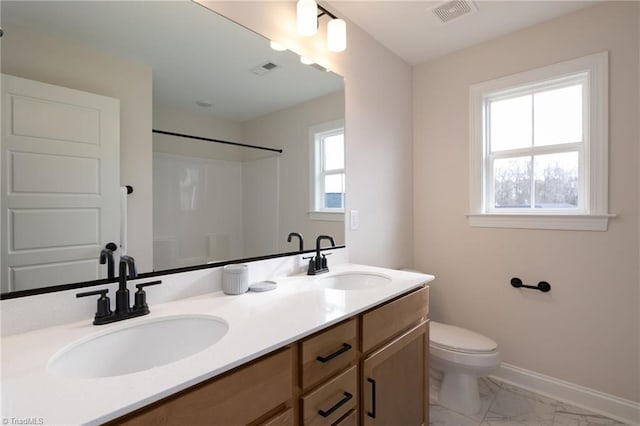 1815 Cleburne Ter, Kernersville, NC 27284 - full bath featuring marble finish floors, toilet, baseboards, double vanity, and a shower