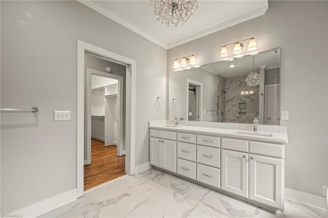 bathroom with a shower stall, a sink, ornamental molding, a notable chandelier, and marble finish floor
